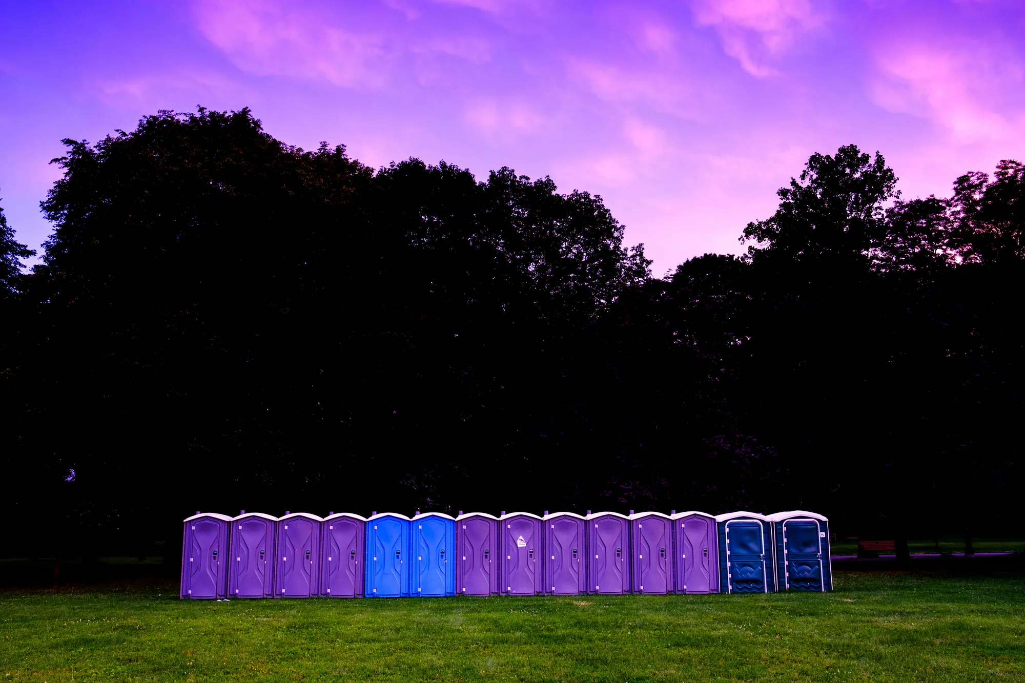 photography of portable toilet on field